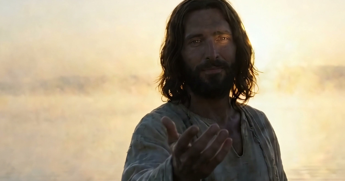 Jesus standing on the water at sunrise, his hand held out toward you.